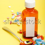 stock-photo-image-of-a-cough-syrup-with-spoon-and-some-pills-isolated-on-yellow-background-37896658